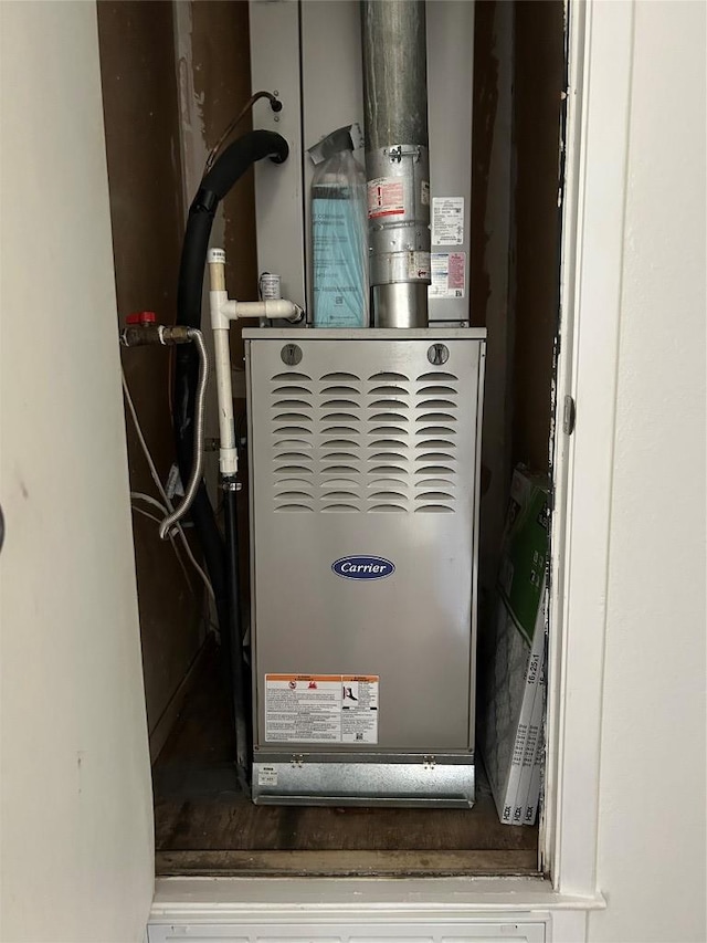 utility room featuring heating unit