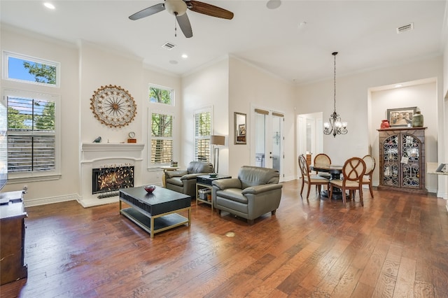 104 Rivalto Cir Unit 1, Lakeway, TX 78734 - living area with healthy amount of natural light, a warm lit fireplace, dark wood-style flooring, a ceiling fan, and ornamental molding