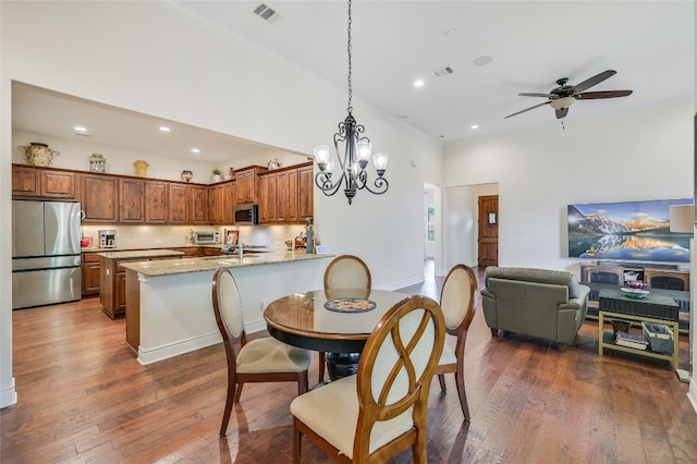 104 Rivalto Cir Unit 1, Lakeway, TX 78734 - dining room featuring a towering ceiling, dark wood finished floors, recessed lighting, ornamental molding, and a chandelier