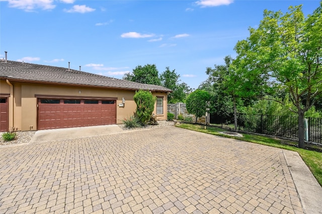 104 Rivalto Cir Unit 1, Lakeway, TX 78734 - view of front facade with decorative driveway, stucco siding, and a garage