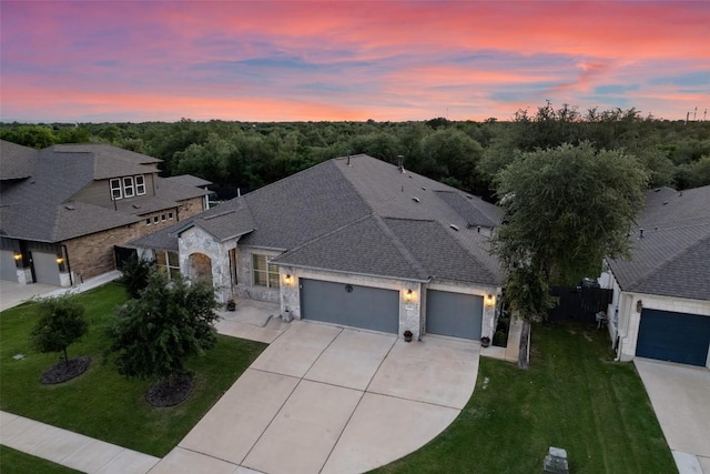 225 Escarpment Way, Cedar Park, TX 78613 - view of front facade featuring stone siding, a garage, driveway, and a front lawn