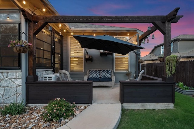 225 Escarpment Way, Cedar Park, TX 78613 - patio terrace at dusk featuring fence and outdoor lounge area