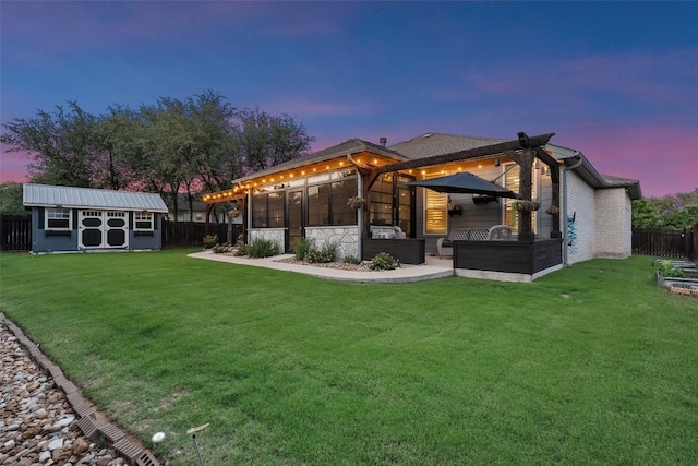 225 Escarpment Way, Cedar Park, TX 78613 - back of property at dusk featuring an outbuilding, a sunroom, and a storage unit