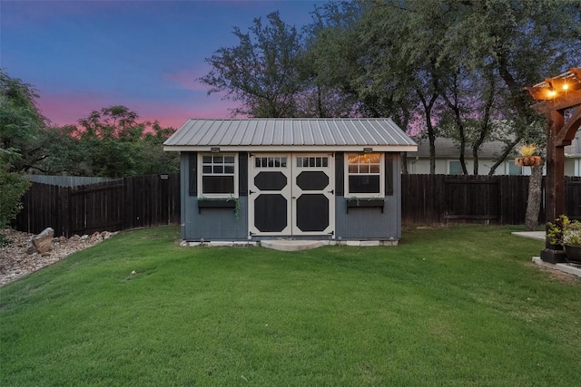 225 Escarpment Way, Cedar Park, TX 78613 - outdoor structure at dusk with a storage shed and an outbuilding