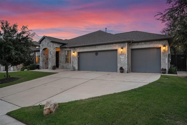225 Escarpment Way, Cedar Park, TX 78613 - view of front of house featuring an attached garage, stone siding, concrete driveway, a lawn, and roof with shingles