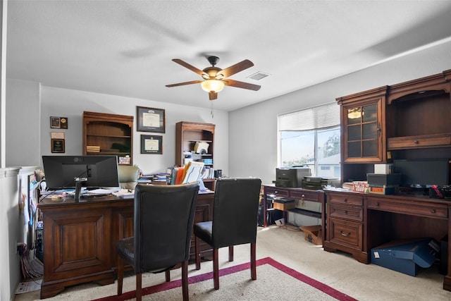 office space featuring ceiling fan and light colored carpet
