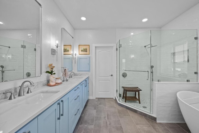 10978 W Cave Blvd, Dripping Springs, TX 78620 - bathroom with a shower stall, a freestanding bath, double vanity, recessed lighting, and tile patterned floors