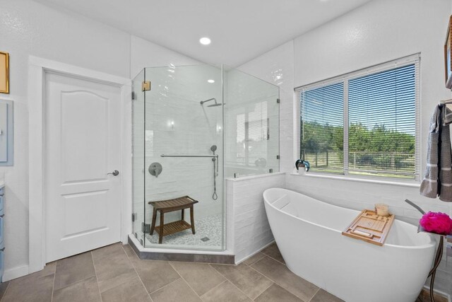 10978 W Cave Blvd, Dripping Springs, TX 78620 - bathroom featuring a shower stall, a freestanding tub, tile patterned flooring, vanity, and recessed lighting