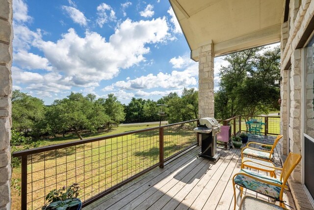 10978 W Cave Blvd, Dripping Springs, TX 78620 - deck featuring a lawn, a grill, and view of scattered trees