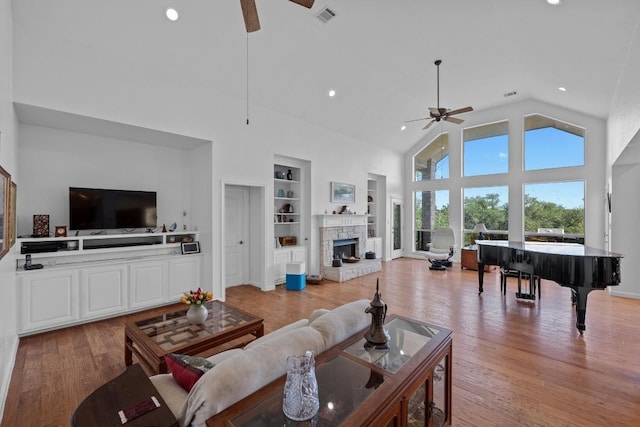 10978 W Cave Blvd, Dripping Springs, TX 78620 - living area with ceiling fan, built in features, a stone fireplace, light wood-type flooring, and recessed lighting