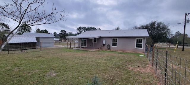 195 Cardinal Dr, Paige, TX 78659 - back of property with a patio area, metal roof, and an outdoor structure