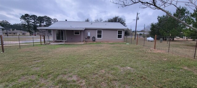 195 Cardinal Dr, Paige, TX 78659 - rear view of property featuring a patio and metal roof