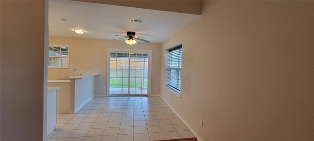 195 Cardinal Dr, Paige, TX 78659 - unfurnished dining area with plenty of natural light, ceiling fan, baseboards, and light tile patterned flooring