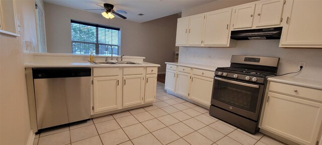 195 Cardinal Dr, Paige, TX 78659 - kitchen featuring appliances with stainless steel finishes, under cabinet range hood, a sink, a ceiling fan, and light tile patterned flooring