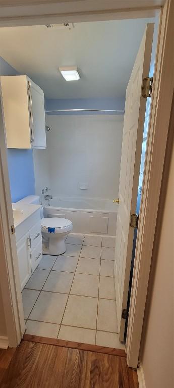 195 Cardinal Dr, Paige, TX 78659 - bathroom featuring toilet, vanity, shower / washtub combination, and tile patterned floors