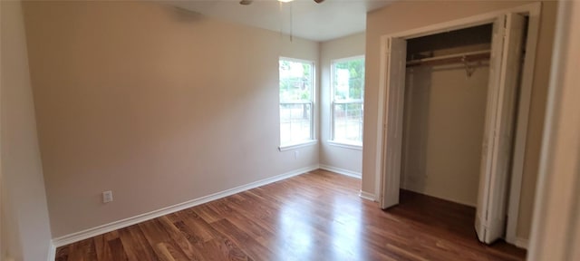 195 Cardinal Dr, Paige, TX 78659 - unfurnished bedroom featuring dark wood-type flooring, a closet, baseboards, and a ceiling fan