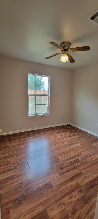 195 Cardinal Dr, Paige, TX 78659 - spare room featuring wood finished floors, baseboards, and ceiling fan