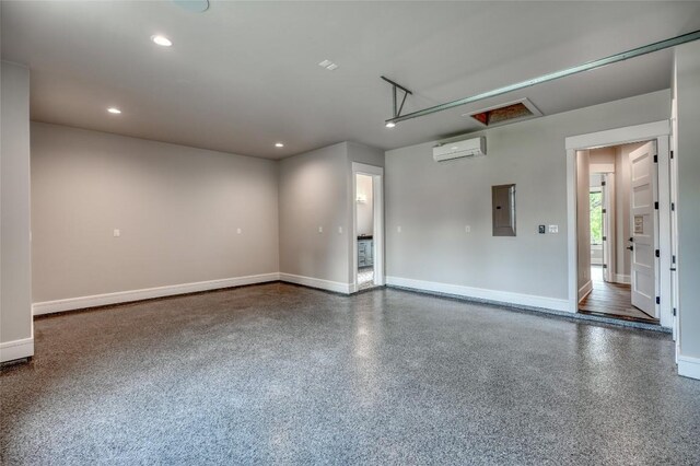 106 Edwards Cir, Horseshoe Bay, TX 78657 - garage with a wall mounted AC, baseboards, recessed lighting, and electric panel