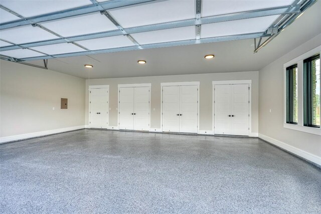 106 Edwards Cir, Horseshoe Bay, TX 78657 - garage with baseboards, electric panel, and recessed lighting