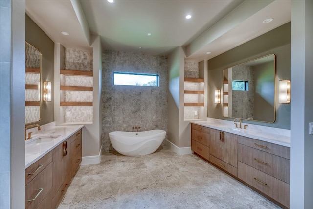 106 Edwards Cir, Horseshoe Bay, TX 78657 - full bathroom with a freestanding bath, two vanities, baseboards, and recessed lighting