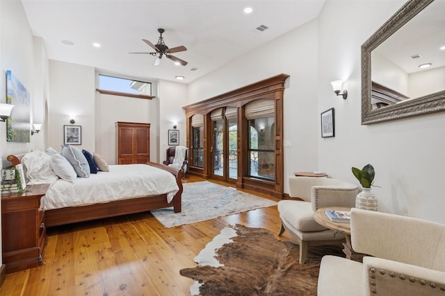 bedroom featuring access to outside, light wood-type flooring, a ceiling fan, and recessed lighting