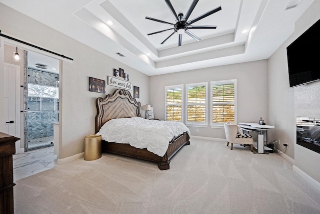 bedroom featuring a raised ceiling, a barn door, a ceiling fan, carpet floors, and recessed lighting