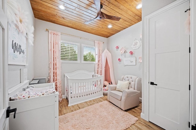 bedroom featuring wooden ceiling, a nursery area, recessed lighting, light wood-type flooring, and a ceiling fan