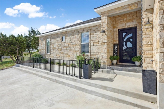 doorway to property with stone siding