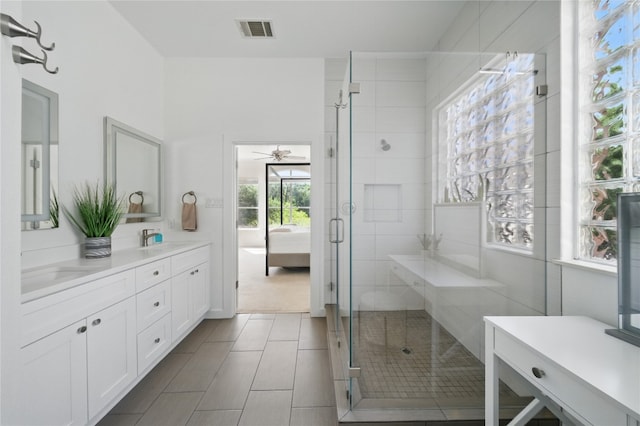 10725 Maelin Dr, Austin, TX 78739 - full bath with a shower stall, double vanity, ceiling fan, and connected bathroom