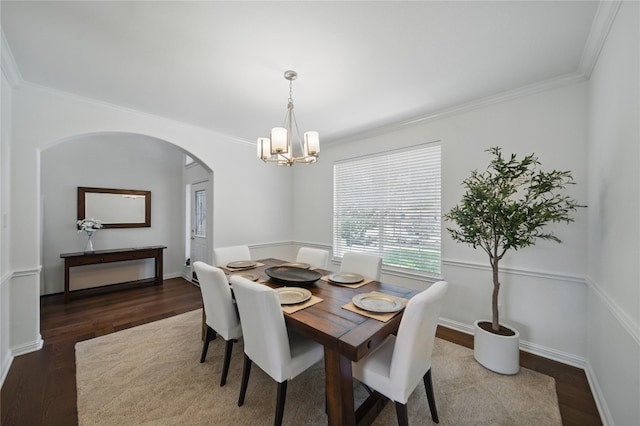 10725 Maelin Dr, Austin, TX 78739 - dining space with arched walkways, a chandelier, dark wood finished floors, ornamental molding, and baseboards