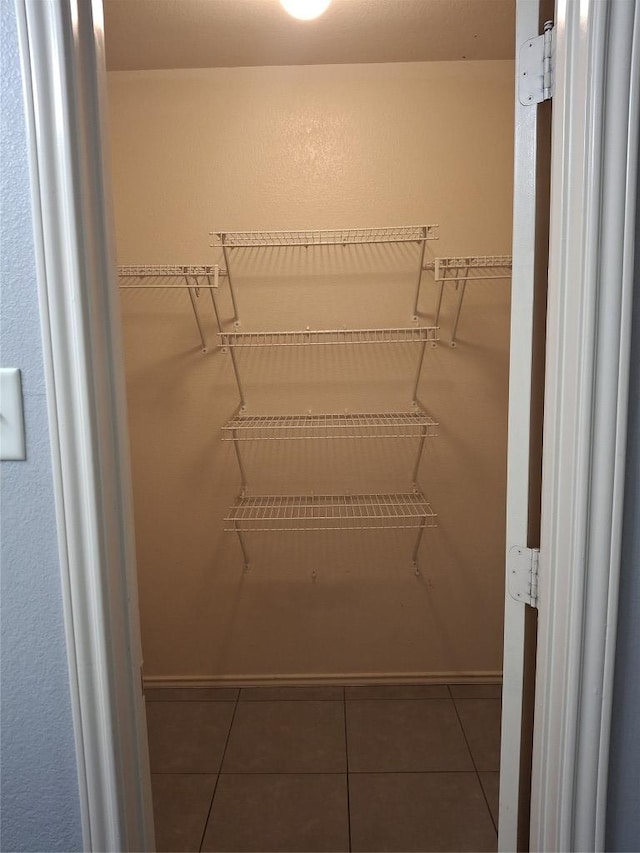 908 Sally Lunn Way, Pflugerville, TX 78660 - walk in closet with tile patterned flooring
