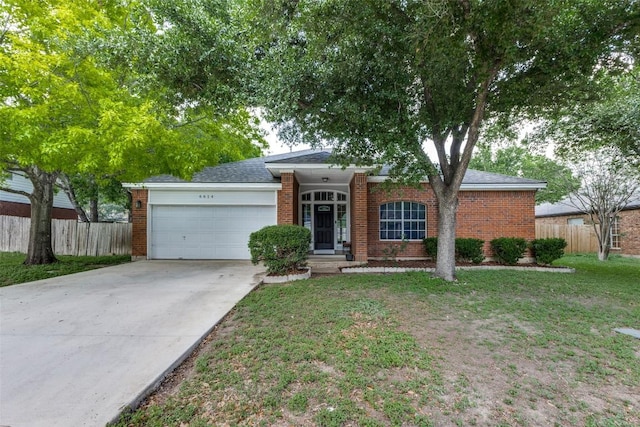 6614 Bramber Ln, Austin, TX 78754 - single story home featuring a garage, brick siding, and concrete driveway