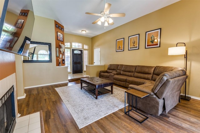 6614 Bramber Ln, Austin, TX 78754 - living room with a ceiling fan, wood finished floors, baseboards, and a fireplace