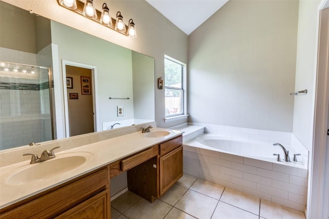 6614 Bramber Ln, Austin, TX 78754 - full bathroom featuring a stall shower, a garden tub, double vanity, tile patterned floors, and lofted ceiling