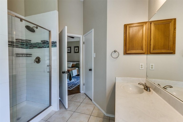 6614 Bramber Ln, Austin, TX 78754 - bathroom featuring connected bathroom, a stall shower, vanity, tile patterned floors, and baseboards