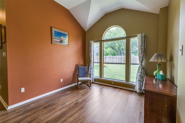 6614 Bramber Ln, Austin, TX 78754 - living area featuring wood finished floors, lofted ceiling, and baseboards
