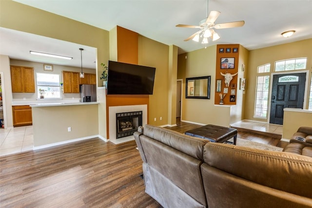 6614 Bramber Ln, Austin, TX 78754 - living area featuring wood finished floors, a fireplace, a ceiling fan, and baseboards