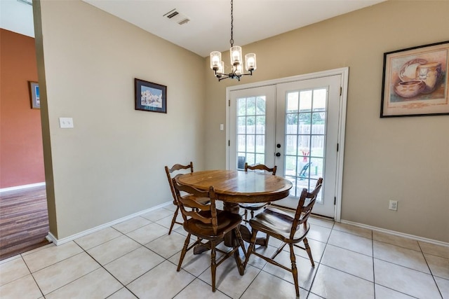 6614 Bramber Ln, Austin, TX 78754 - dining area featuring french doors, a chandelier, baseboards, and light tile patterned flooring