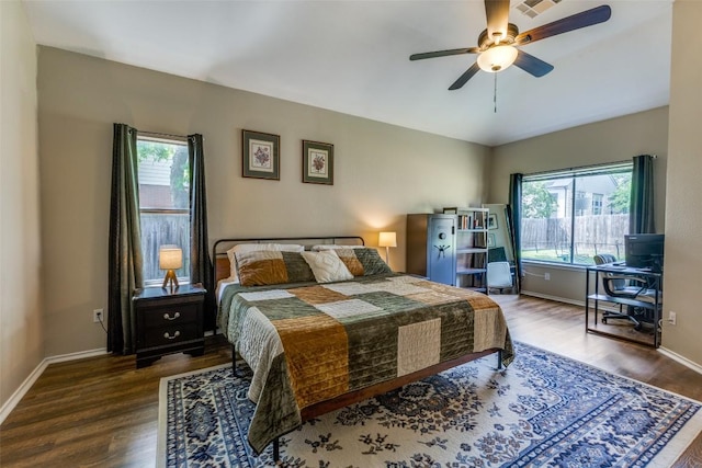 6614 Bramber Ln, Austin, TX 78754 - bedroom featuring multiple windows, wood finished floors, and baseboards