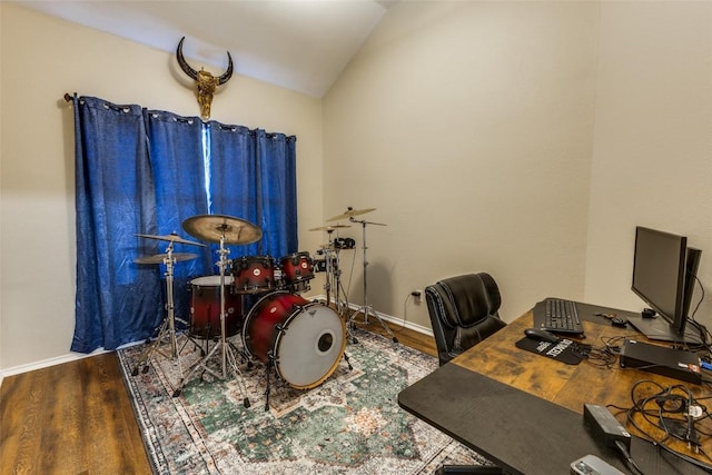 6614 Bramber Ln, Austin, TX 78754 - home office featuring lofted ceiling, wood finished floors, and baseboards