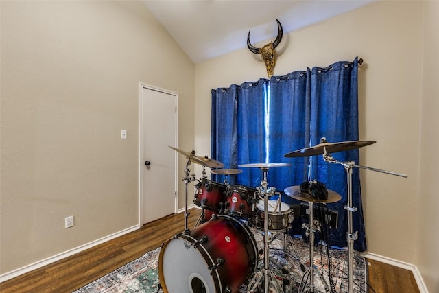 6614 Bramber Ln, Austin, TX 78754 - game room with wood finished floors, vaulted ceiling, and baseboards