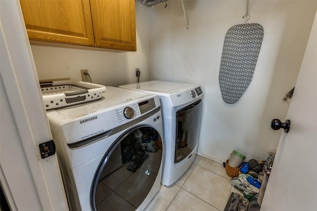 6614 Bramber Ln, Austin, TX 78754 - laundry area with cabinet space, independent washer and dryer, and light tile patterned floors