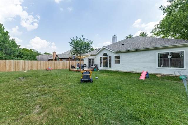 6614 Bramber Ln, Austin, TX 78754 - back of house with a deck, a chimney, and a shingled roof