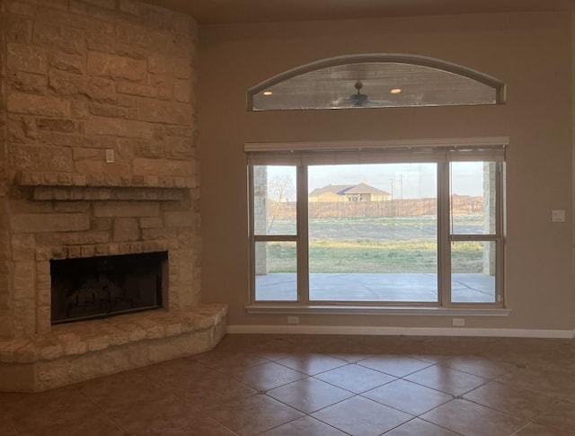129 S Abrego Xing, Floresville, TX 78114 - doorway to outside with baseboards, tile patterned flooring, plenty of natural light, and a fireplace