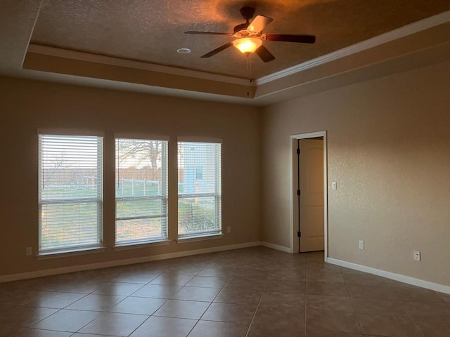 129 S Abrego Xing, Floresville, TX 78114 - empty room featuring a tray ceiling, a ceiling fan, crown molding, baseboards, and tile patterned floors