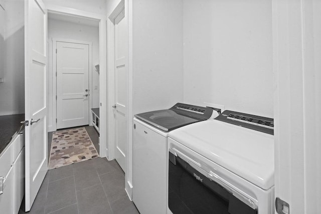 301 Eocene, Horseshoe Bay, TX 78657 - laundry room featuring washing machine and dryer, dark tile patterned flooring, and cabinet space
