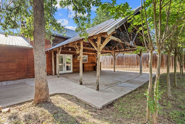 view of patio featuring french doors and fence