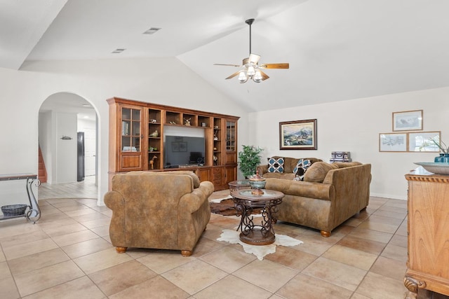 living area featuring a ceiling fan, arched walkways, high vaulted ceiling, and light tile patterned floors
