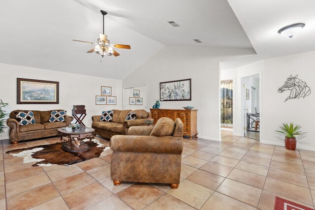 living area with ceiling fan, light tile patterned floors, high vaulted ceiling, and baseboards