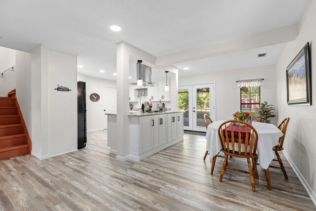 969 N State Highway 95, Bastrop, TX 78602 - dining space with light wood-style flooring, stairs, french doors, and recessed lighting